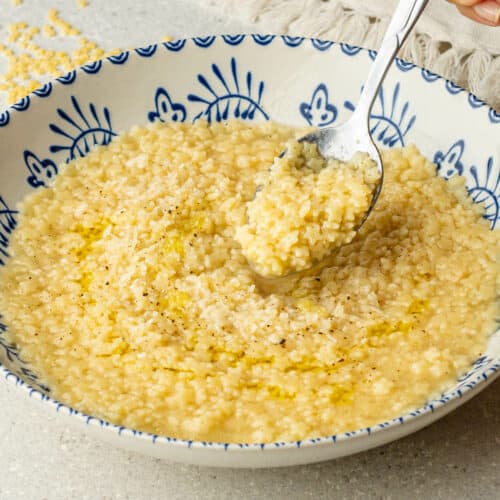 Spoon of Pastina coming out of a bowl
