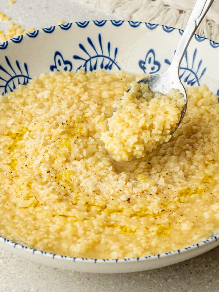 Spoon of Pastina coming out of a bowl