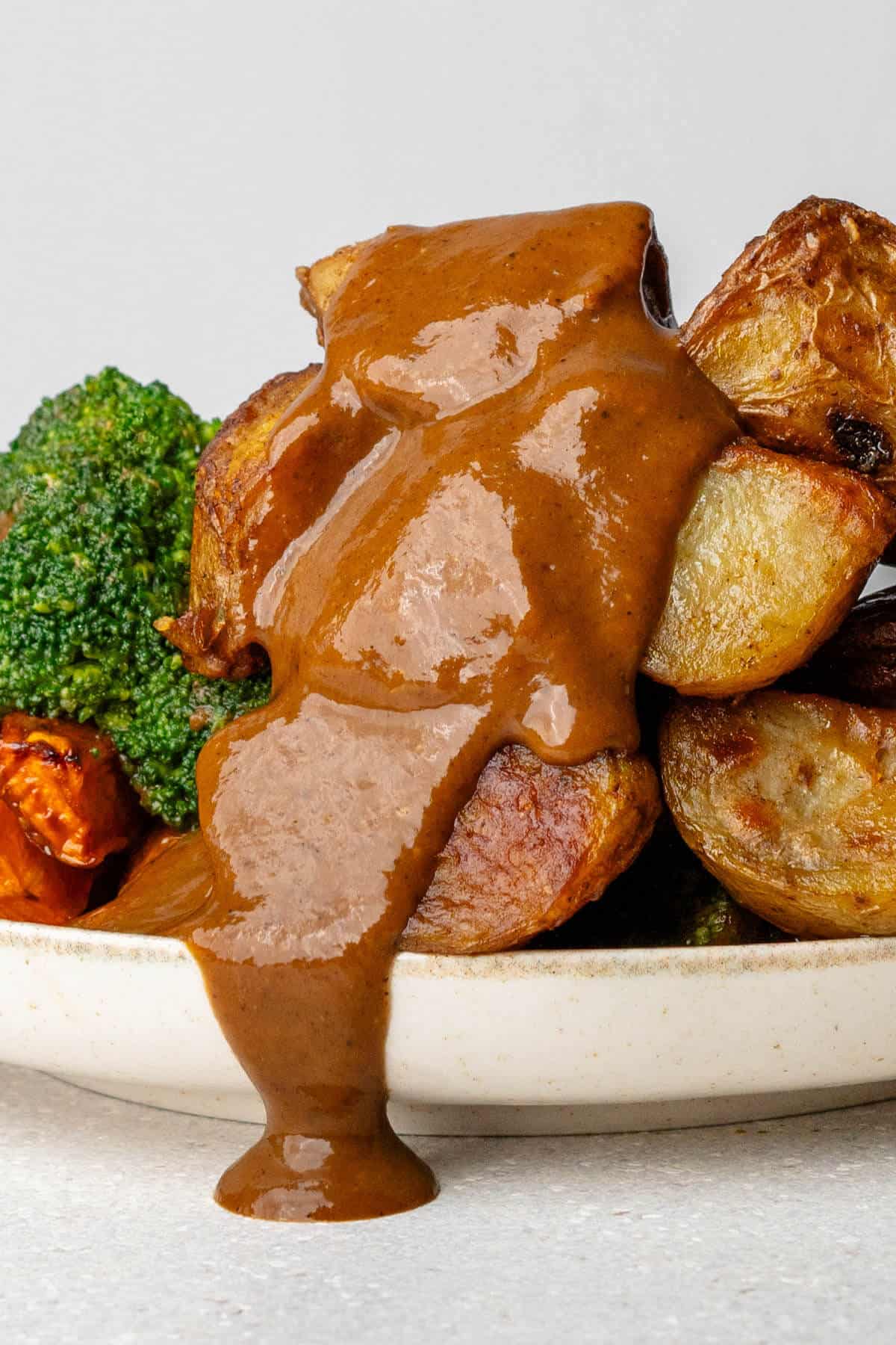 Close up of gravy topped on roasted vegetables