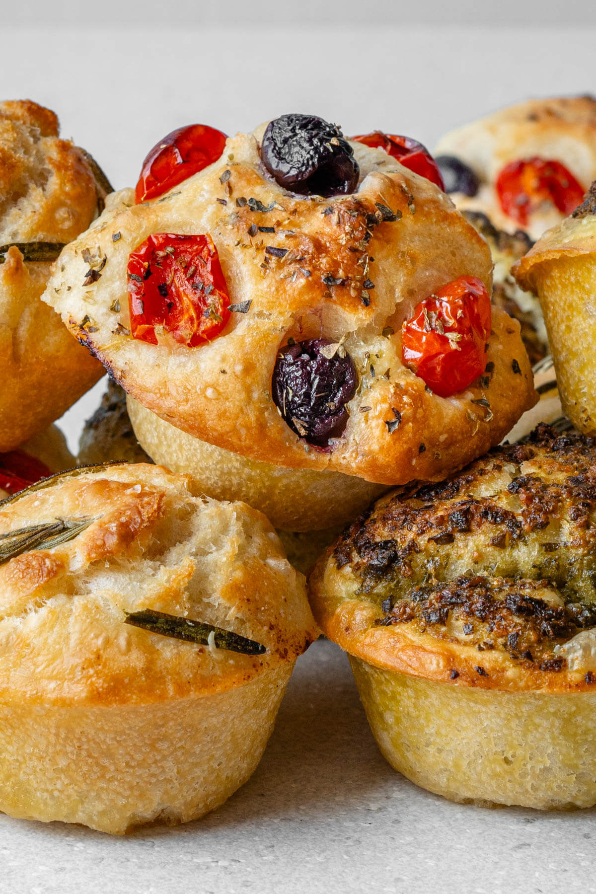 Stack of focaccia muffins with 3 different flavors