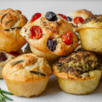 Stack of focaccia muffins with 3 flavors