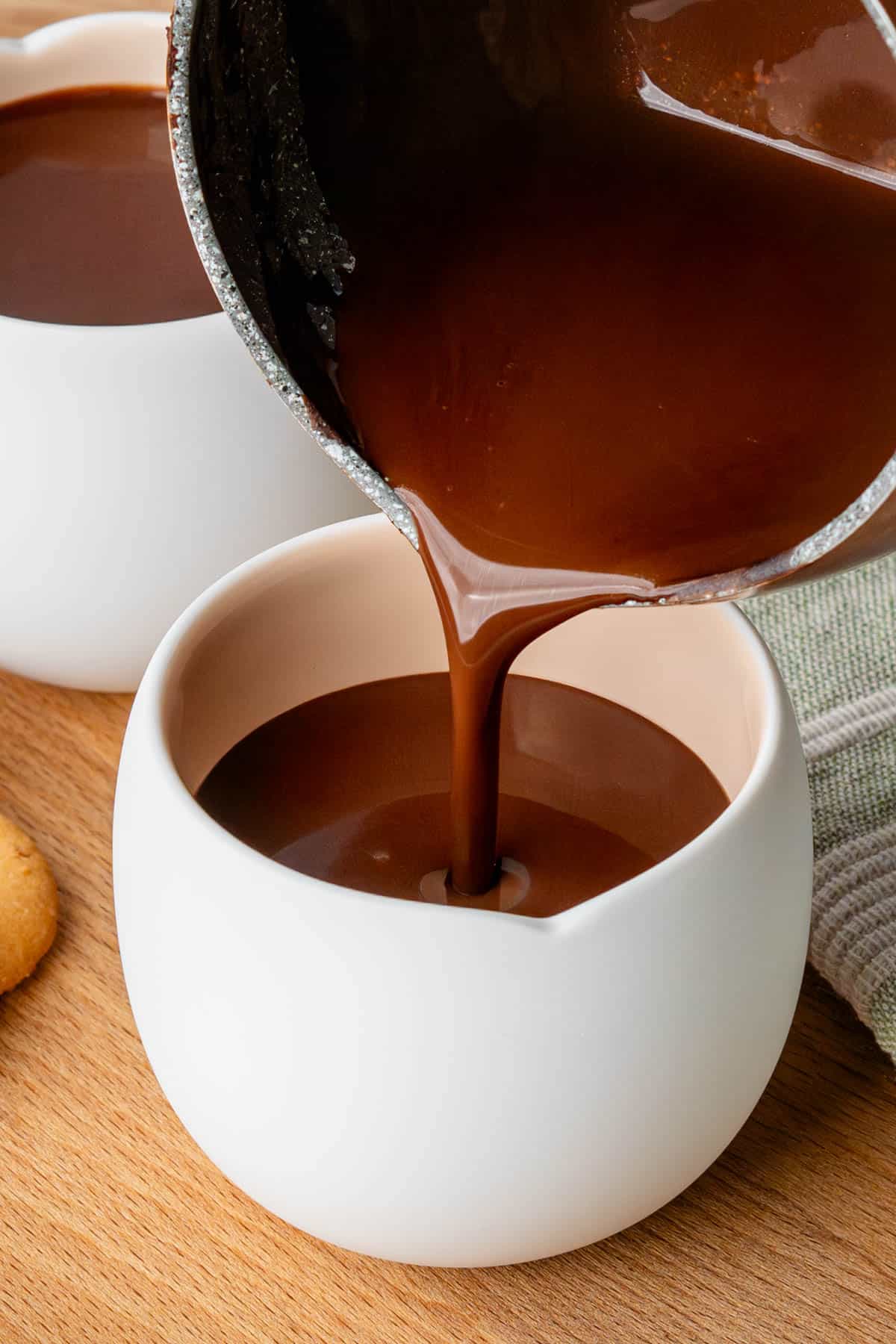 Pot of Italian Hot Chocolate being poured into a mug