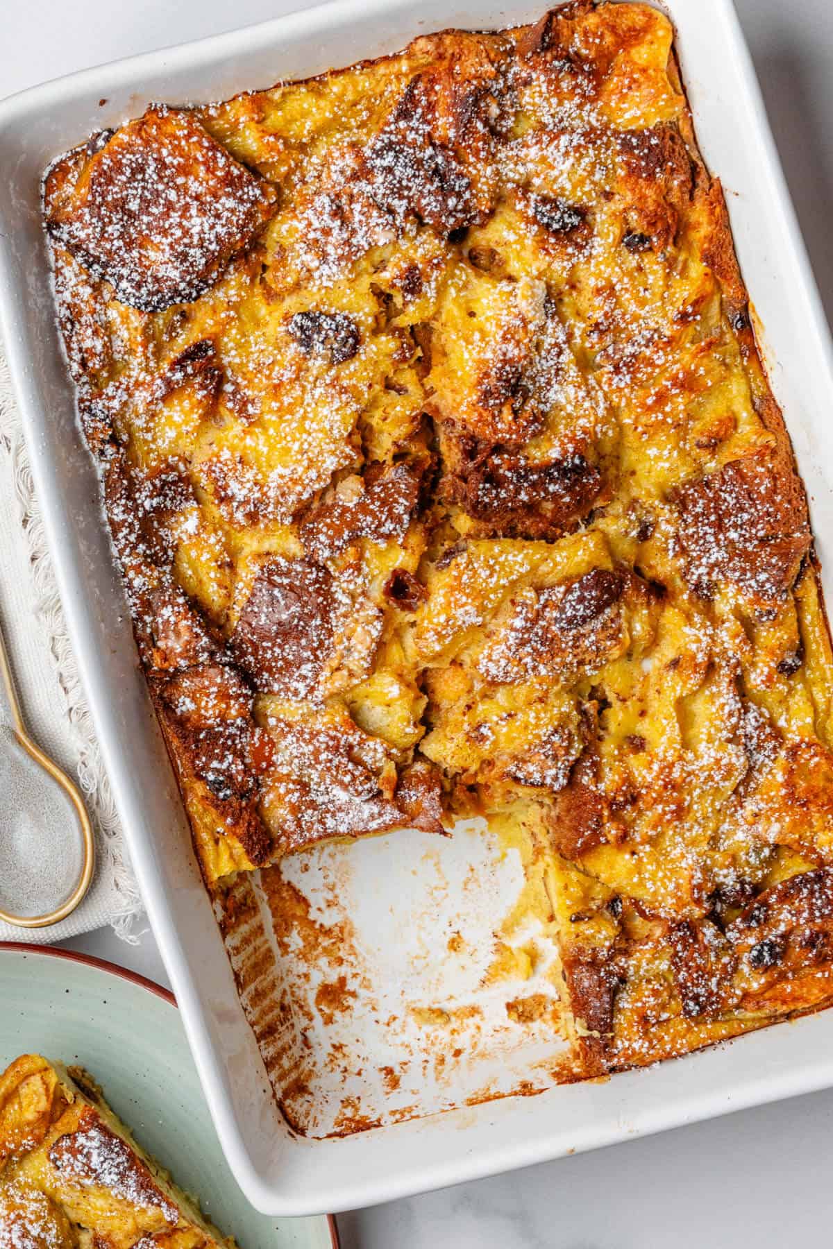 Panettone bread pudding with a piece served on a plate