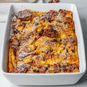 Panettone bread pudding in an oven tray dusted with icing sugar