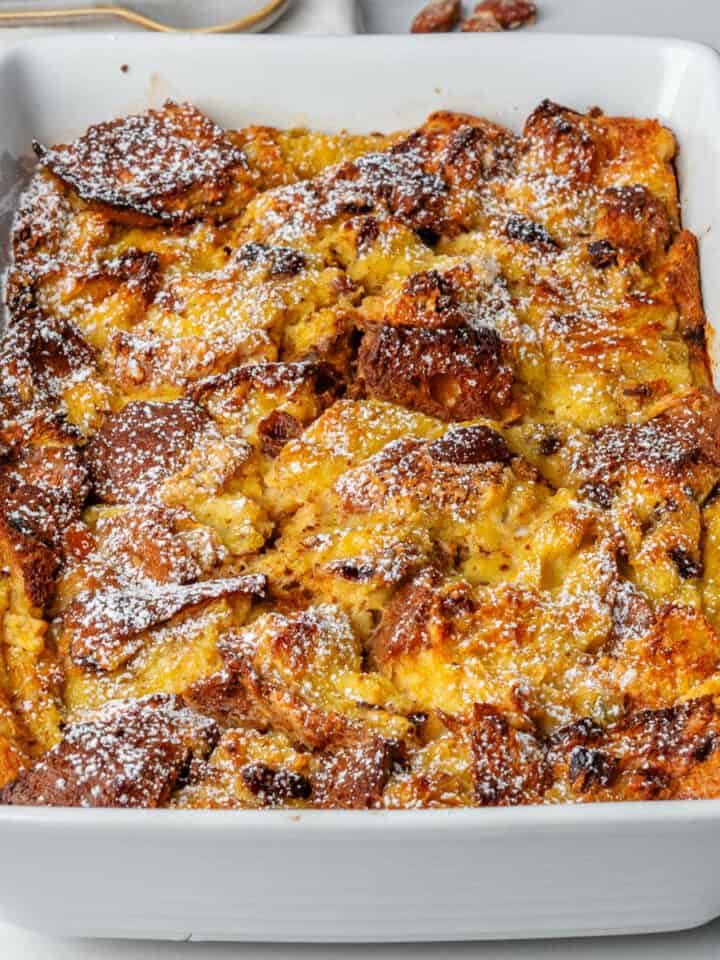Panettone bread pudding in an oven tray dusted with icing sugar