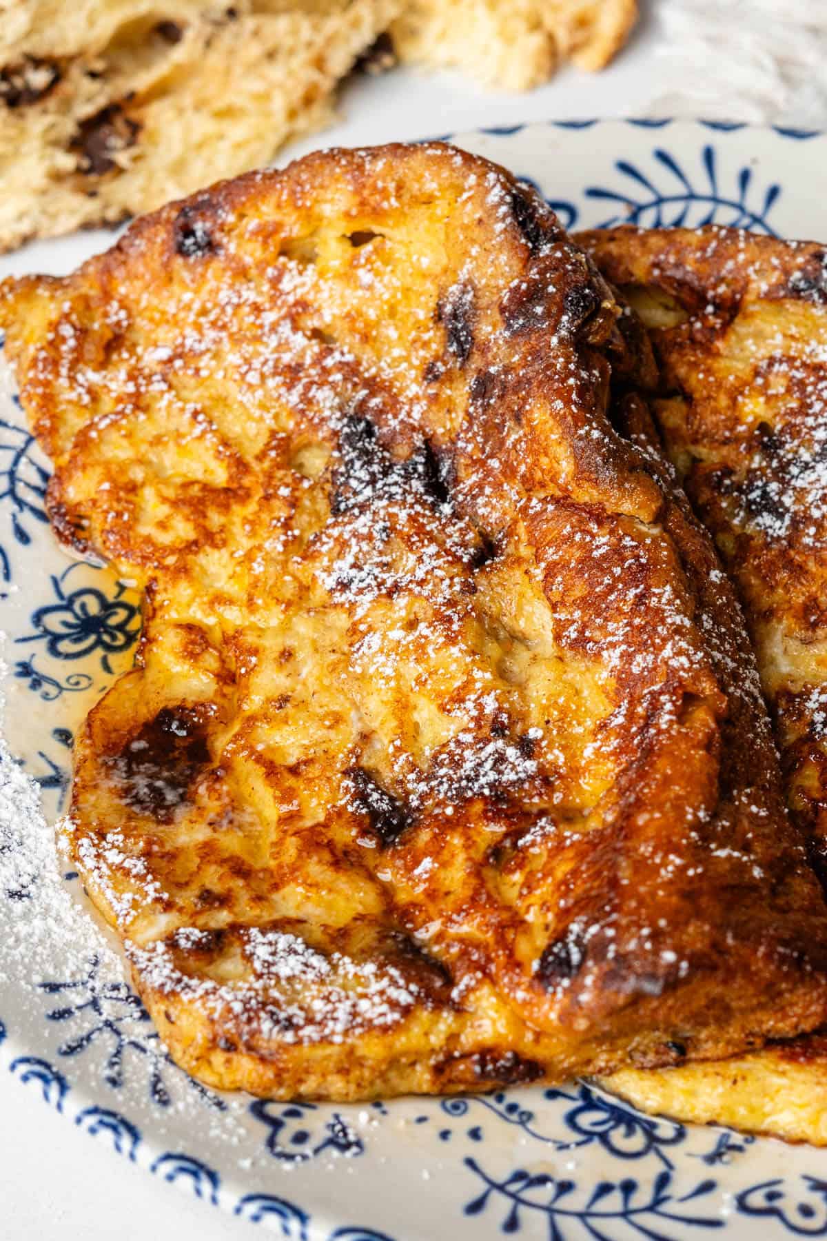 Panettone french toast topped maple syrup and icing sugar