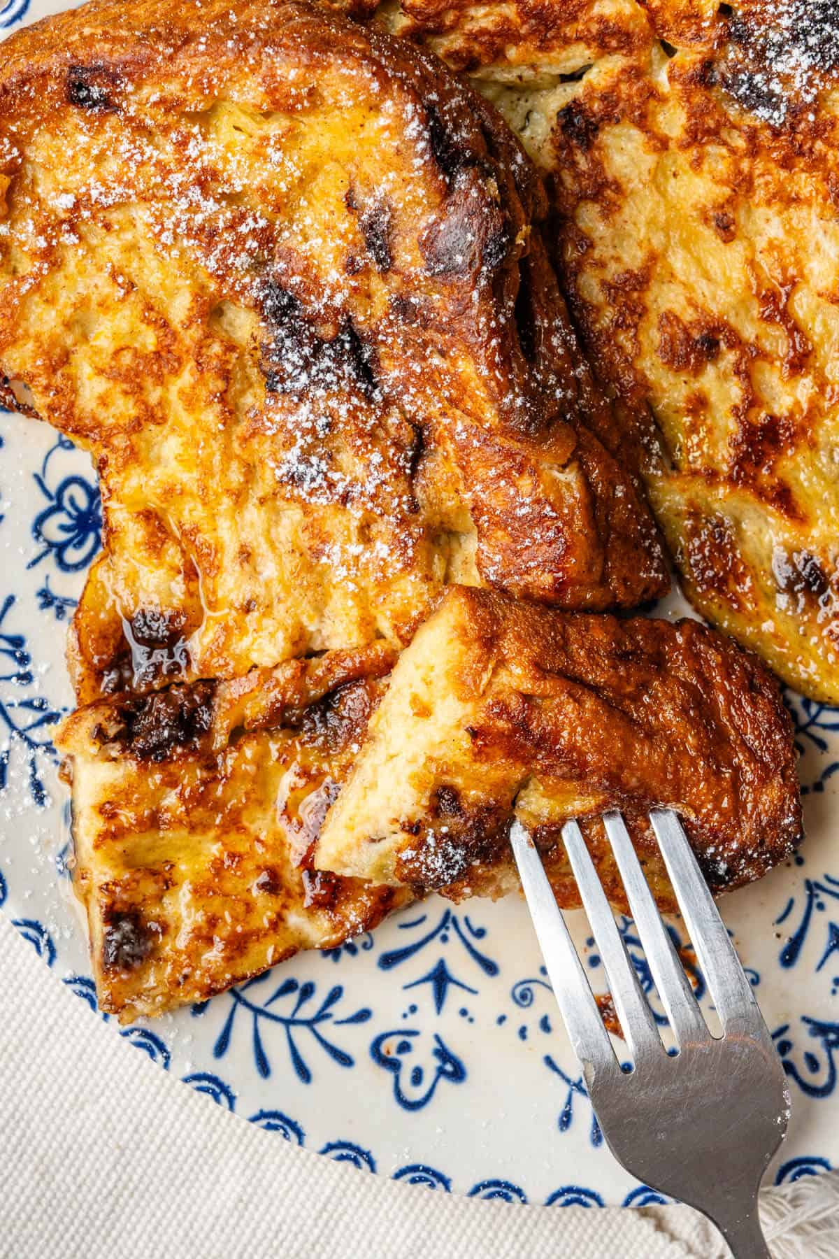Piece of Panettone french toast with a fork in it