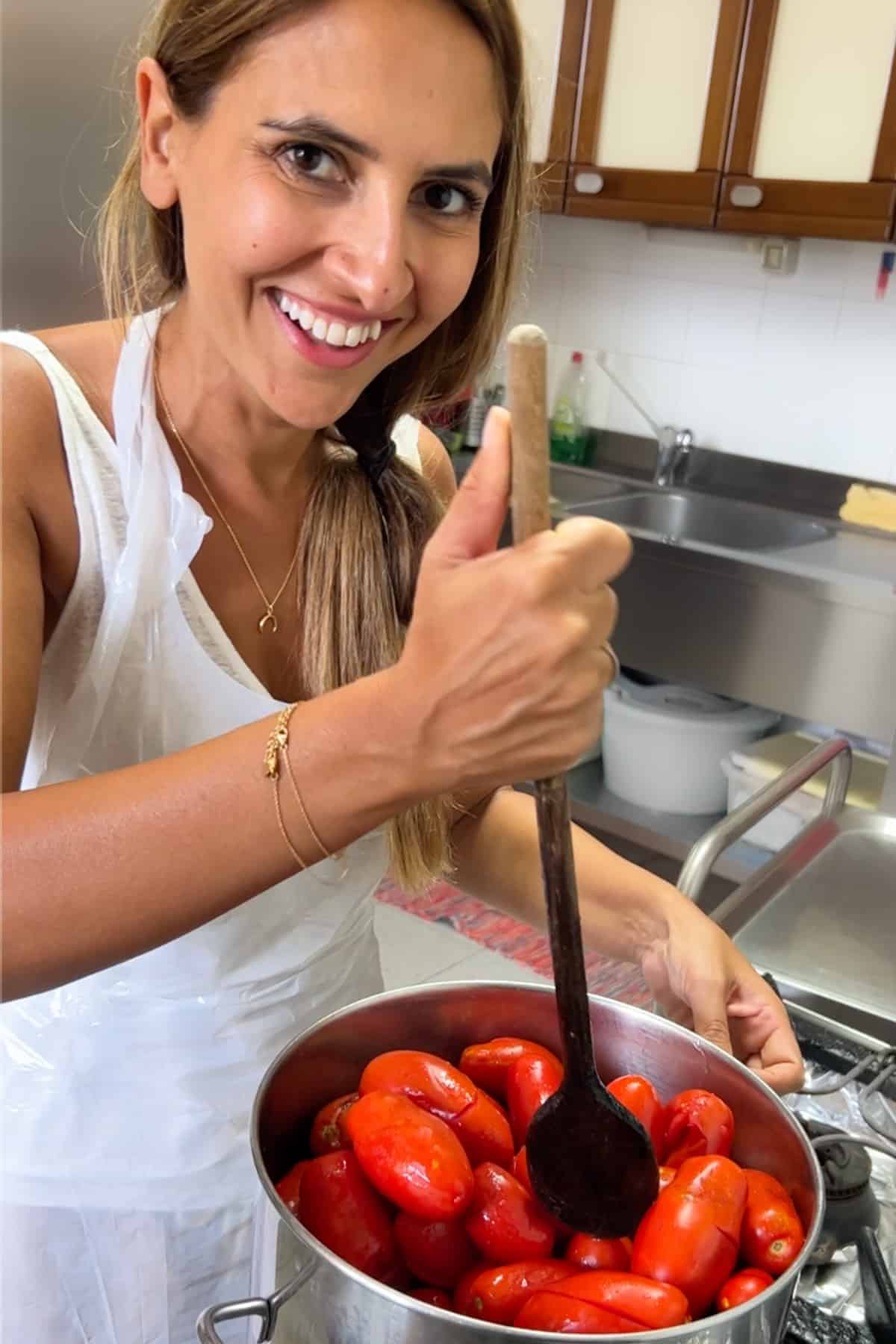Ayeh cooking a big pot of tomatoes