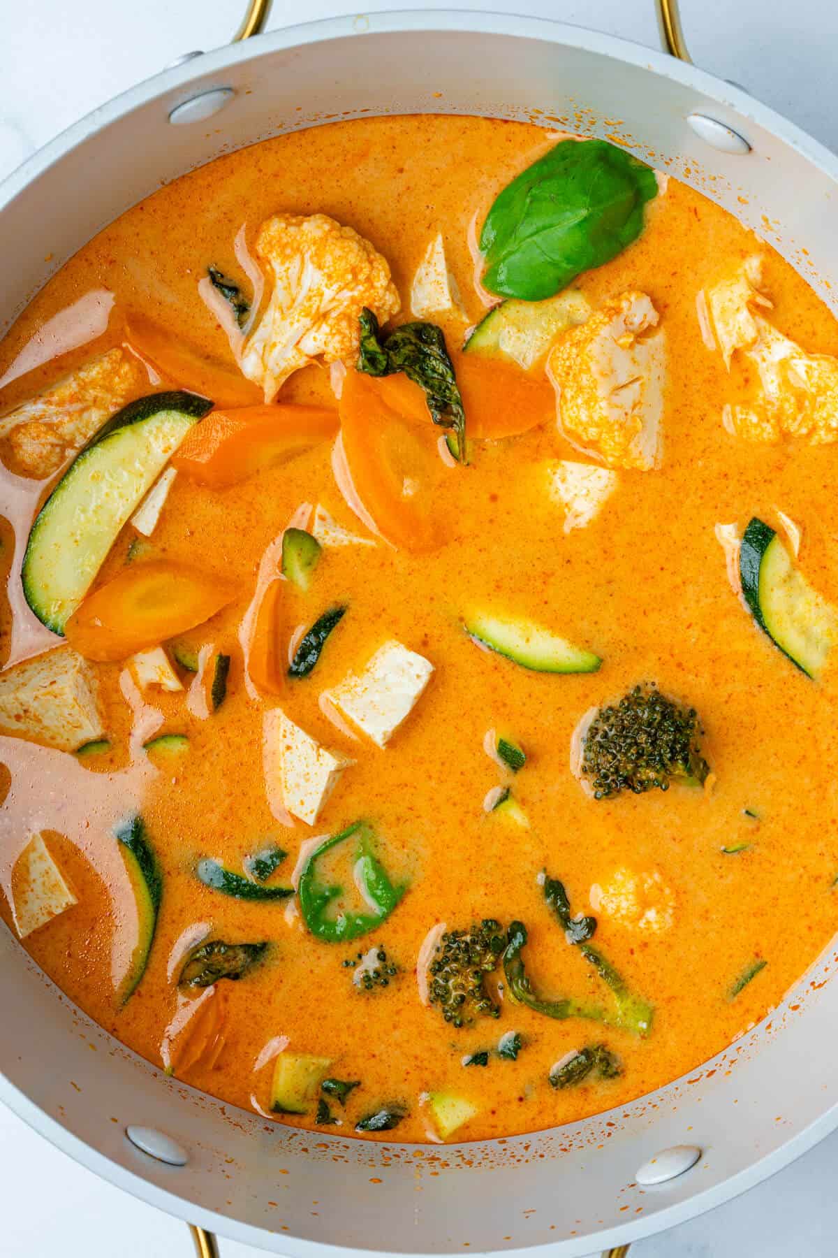 Pot of Thai Red Curry Soup with tofu and veggies