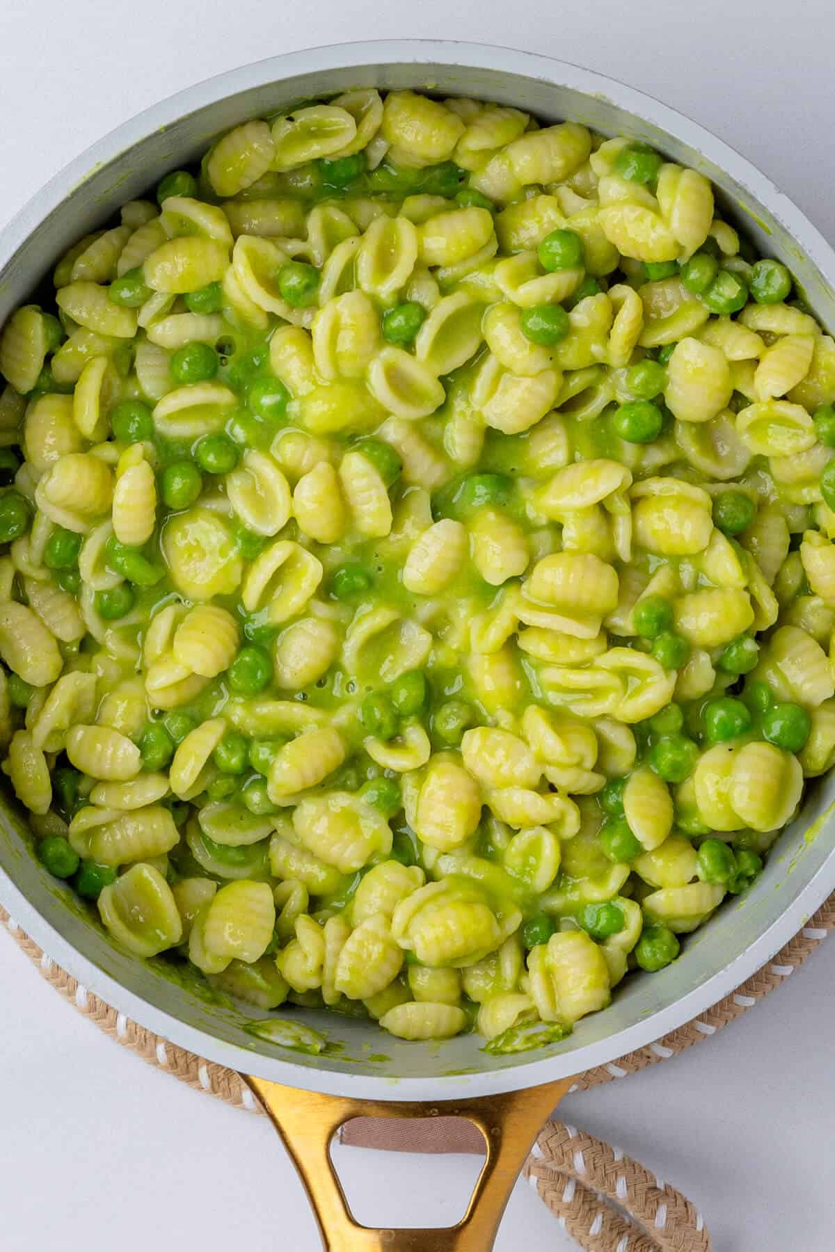 Cooked pasta with peas in a pot