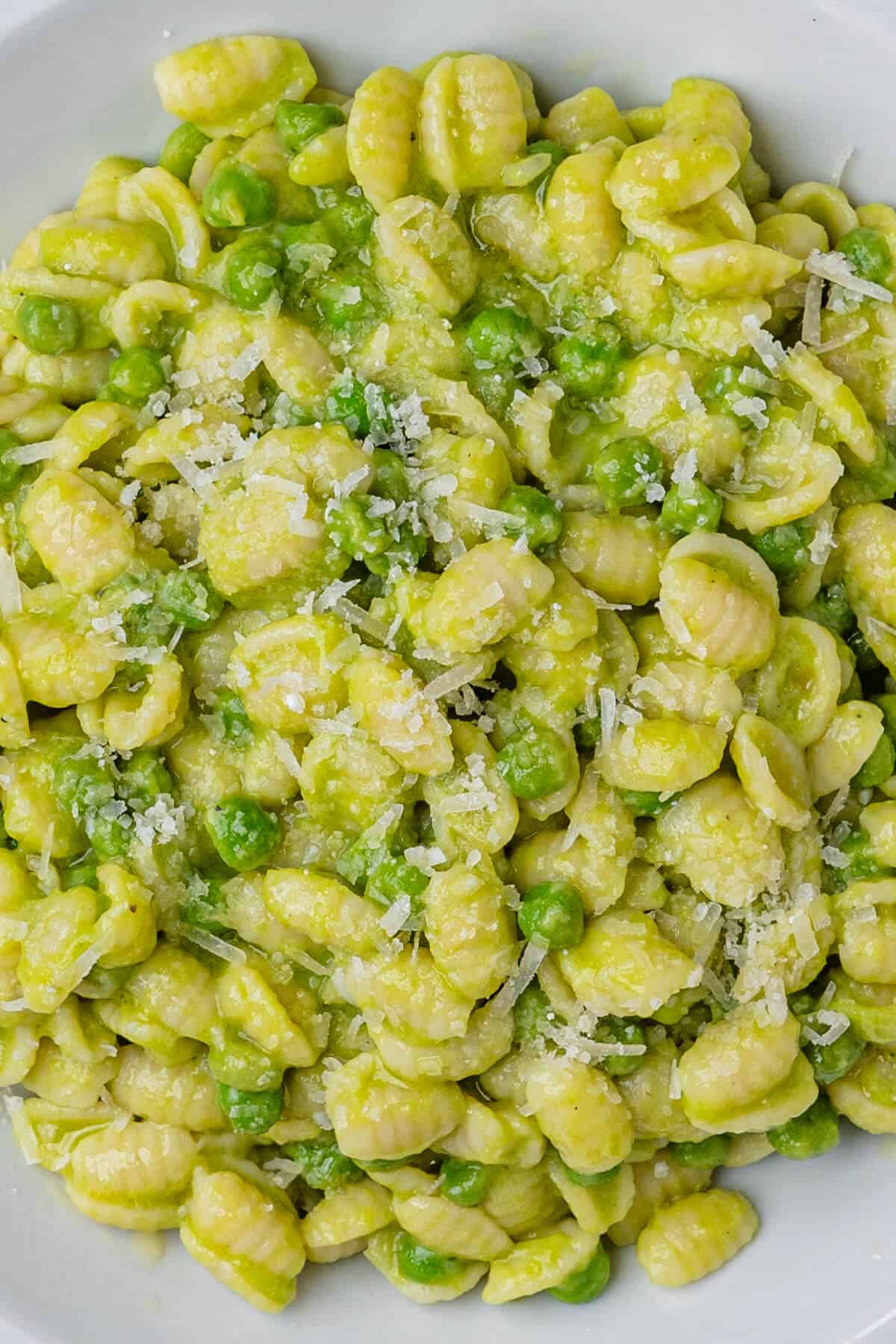 Close up of pasta and peas with parmesan cheese