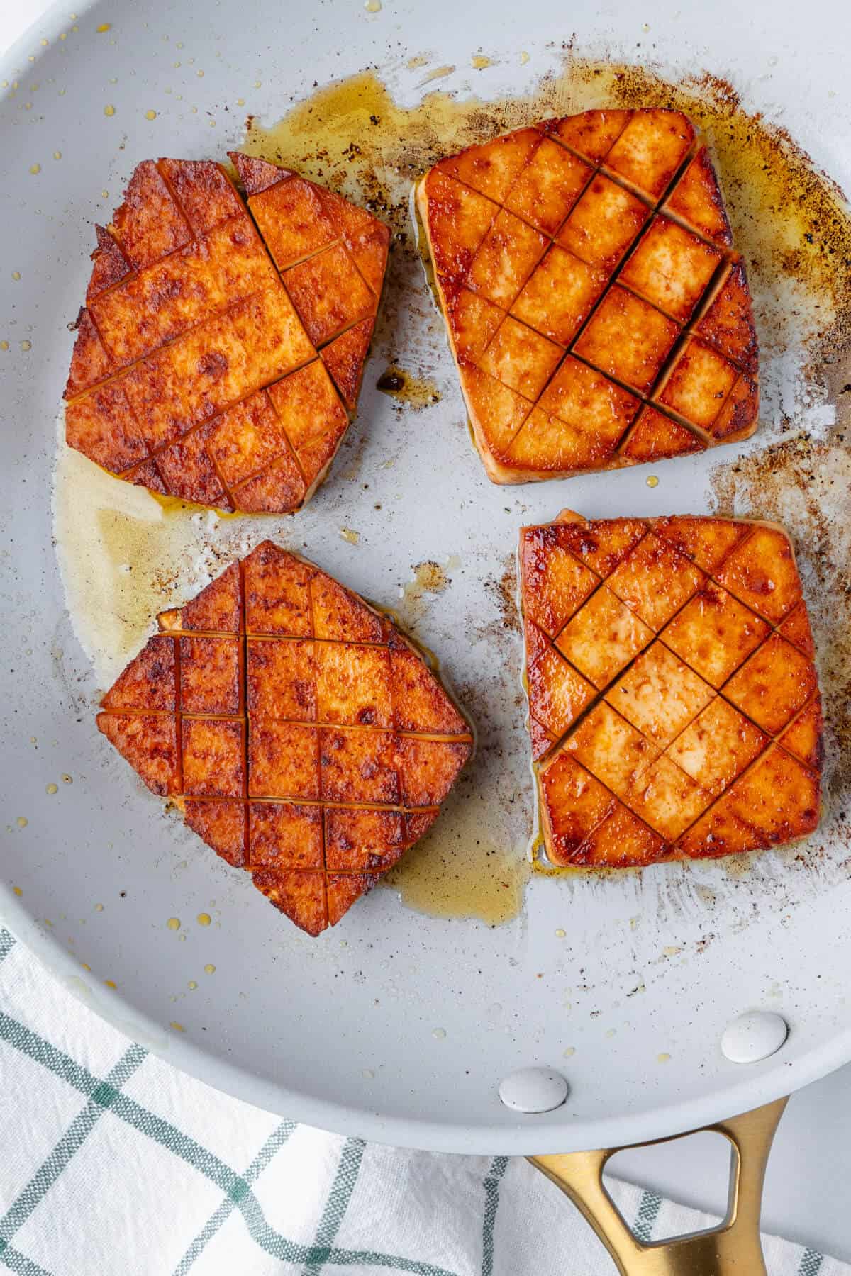 Cooked tofu steaks on a fry pan