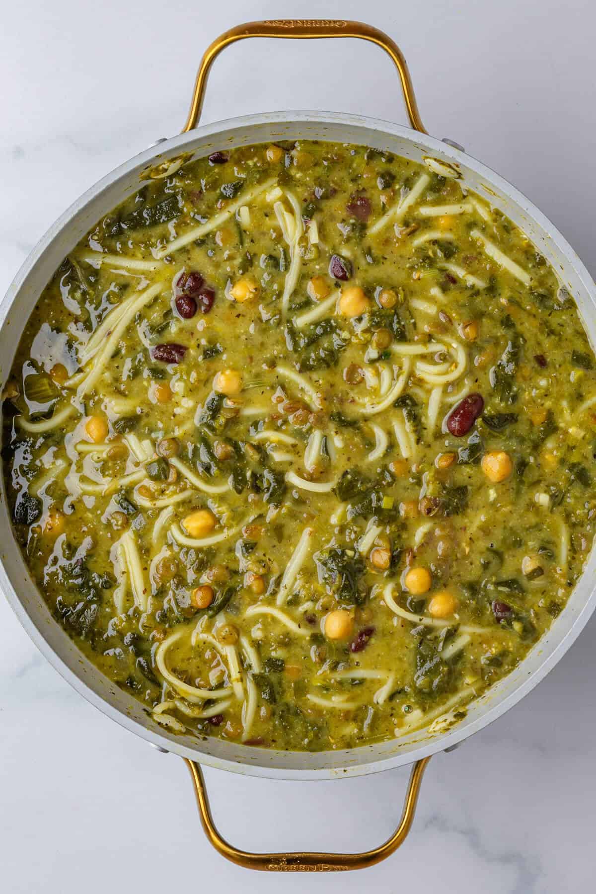 Ash Reshteh Persian Noodle Herb Soup in a big pot