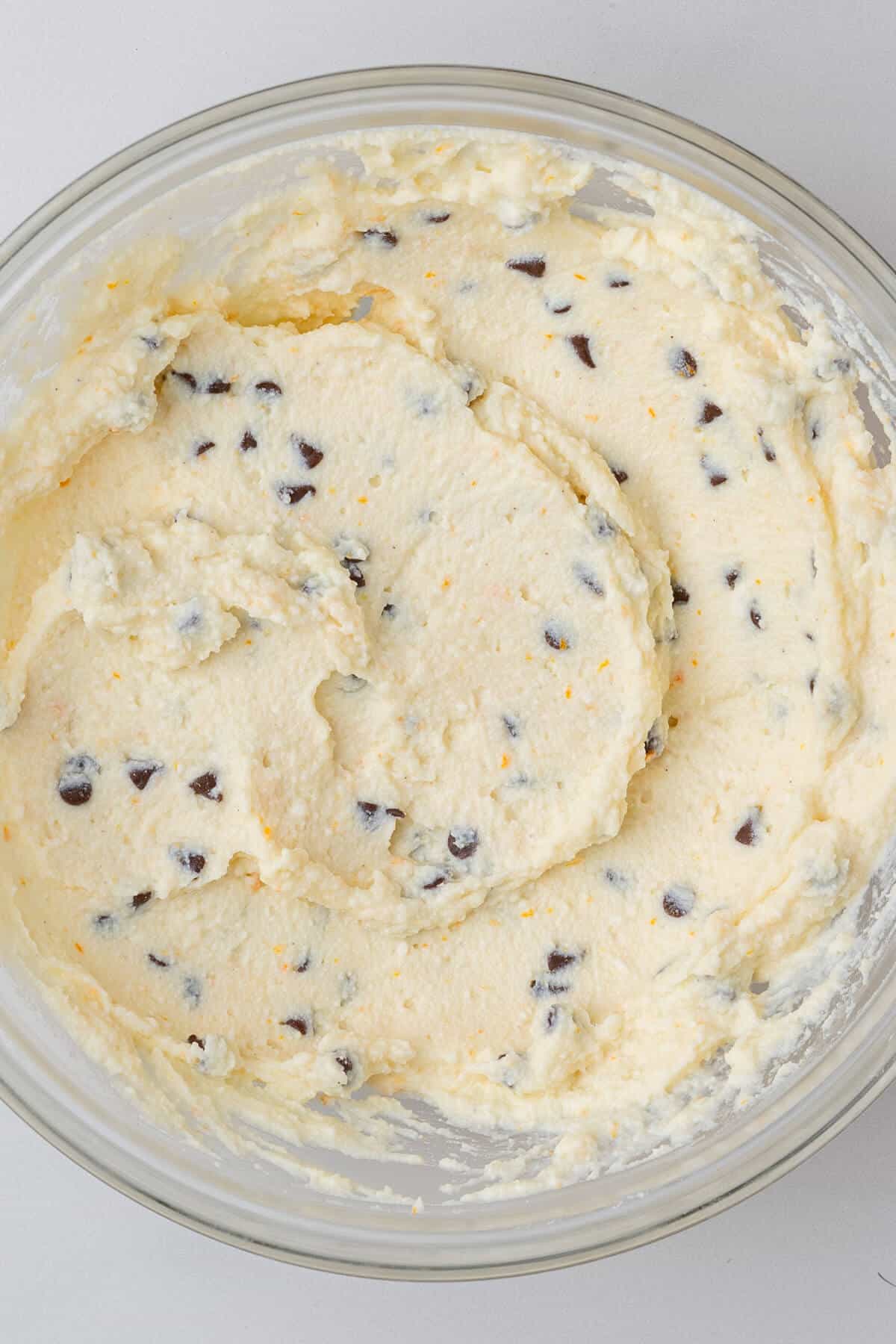 Cannoli mixture in a bowl after being mixed with chocolate chips