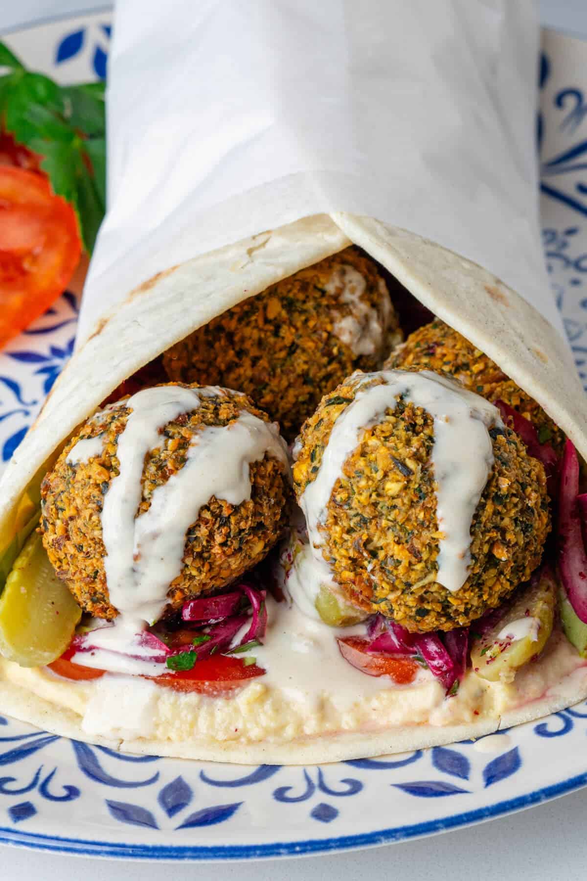 Falafel wrap with tahini dressing on top