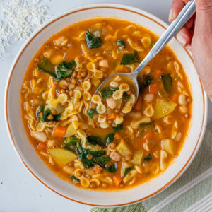 Italian minestrone soup with a spoon coming out of the bowl
