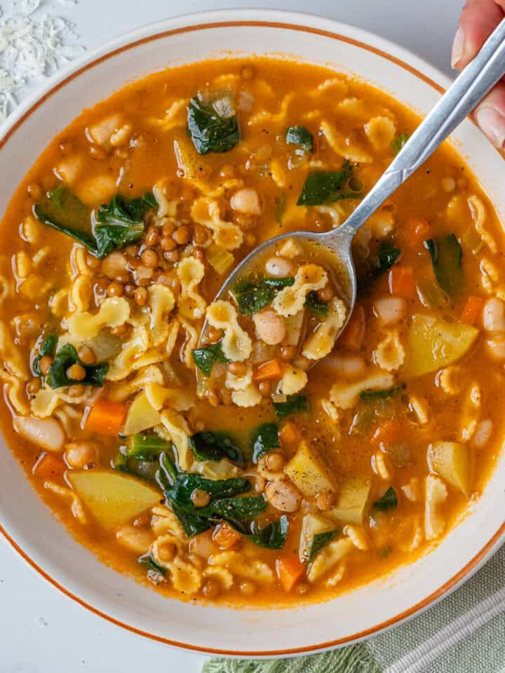 Italian minestrone soup with a spoon coming out of the bowl