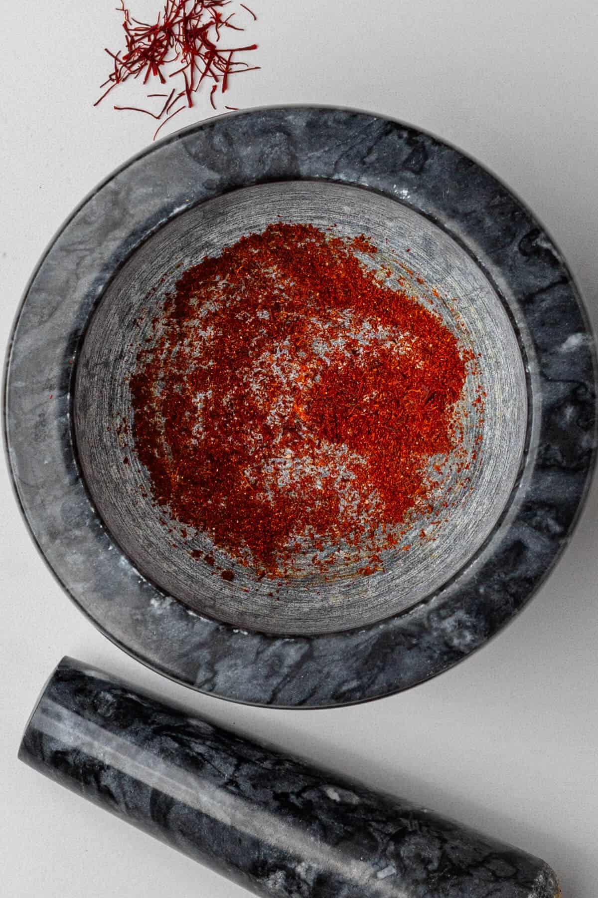 Saffron grinded in a mortar and pestle