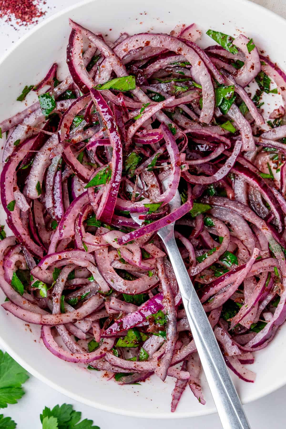 Fork in a bowl of sumac onions