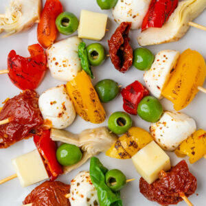 Antipasto skewers on a plate with mixed ingredients