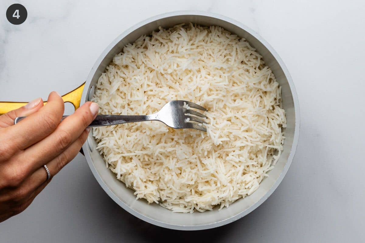 Step 4 to fluff rice with a fork