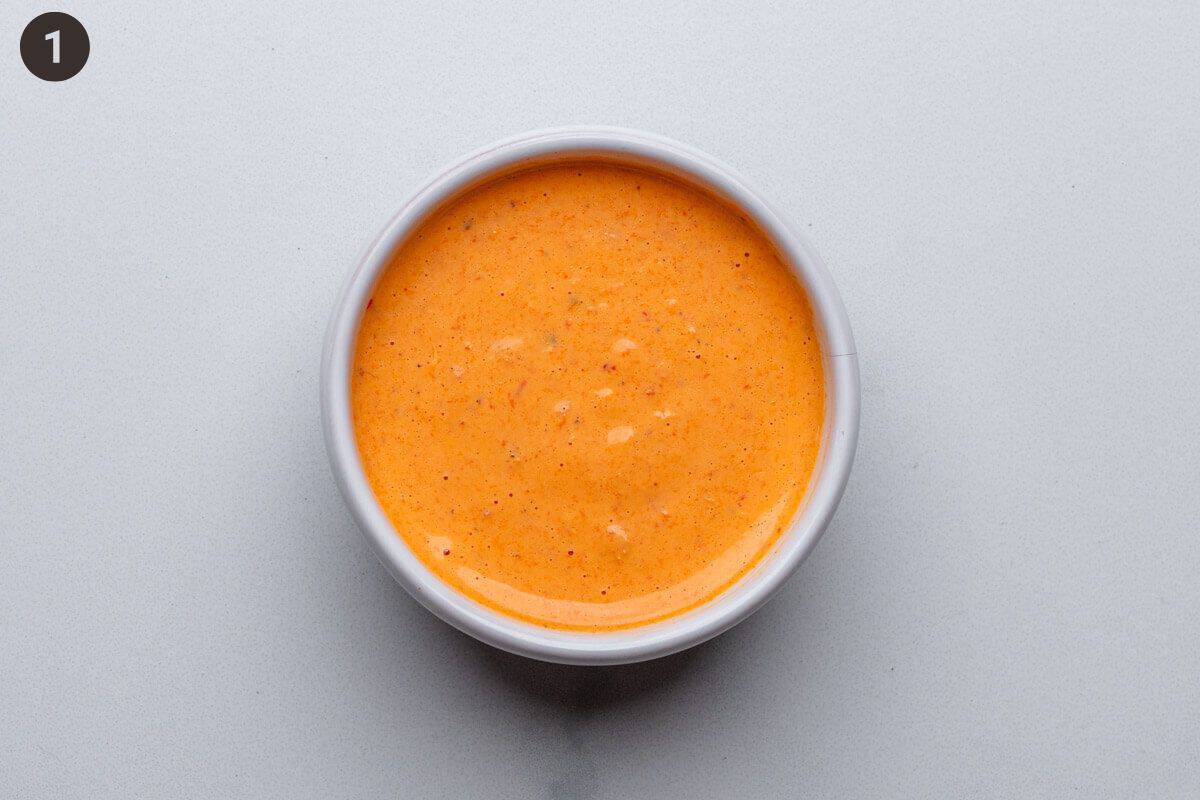 Spicy red pepper sauce in a ramekin after being blended