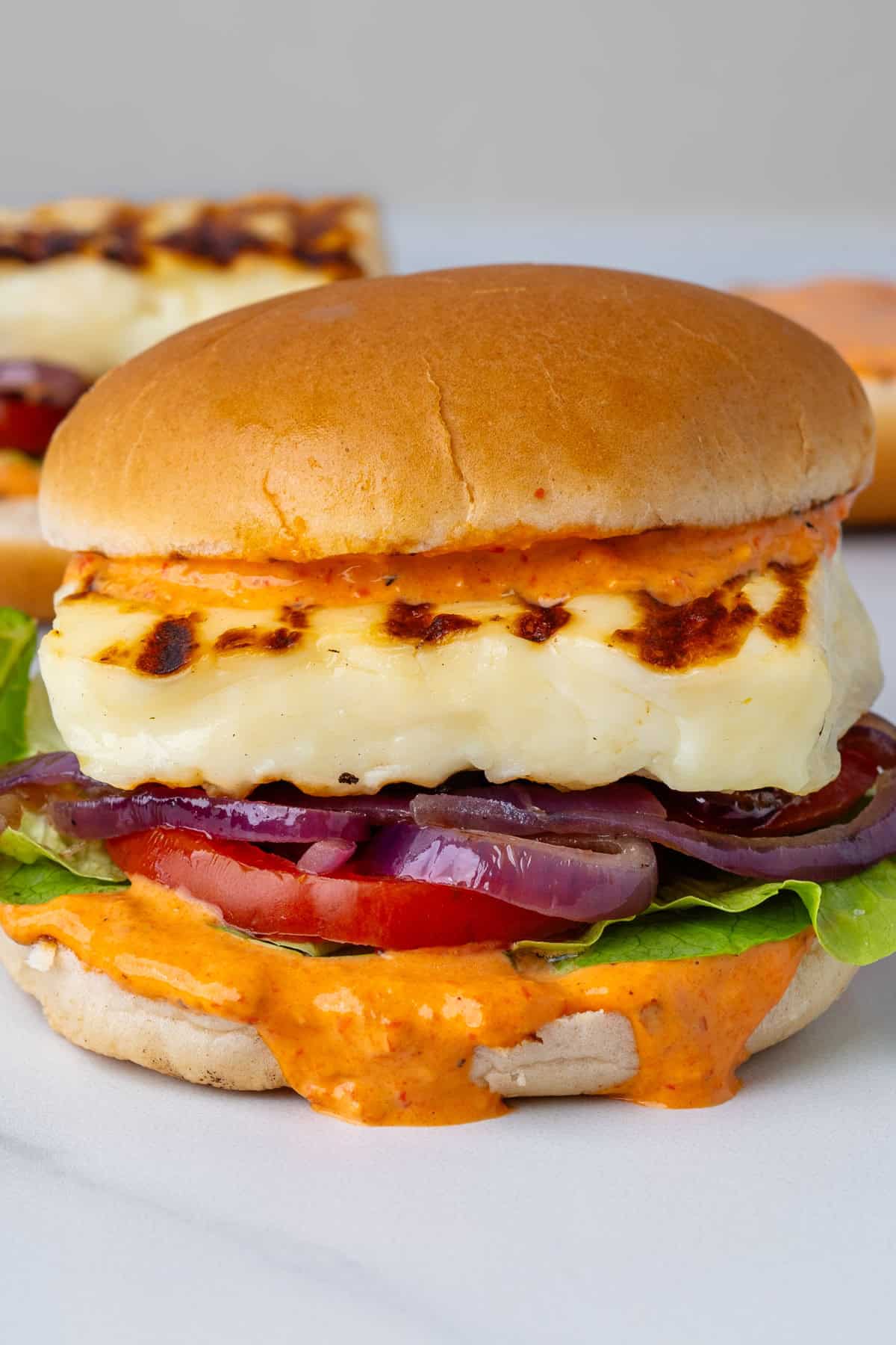 Halloumi burger with a smoky red pepper sauce and veggies
