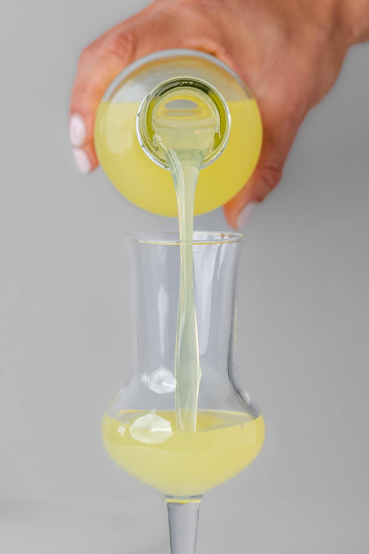 Limoncello being poured into a shot glass
