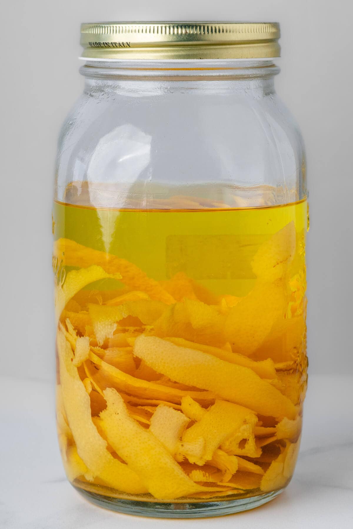 Large jar of lemon rinds with alcohol after 25 days resting