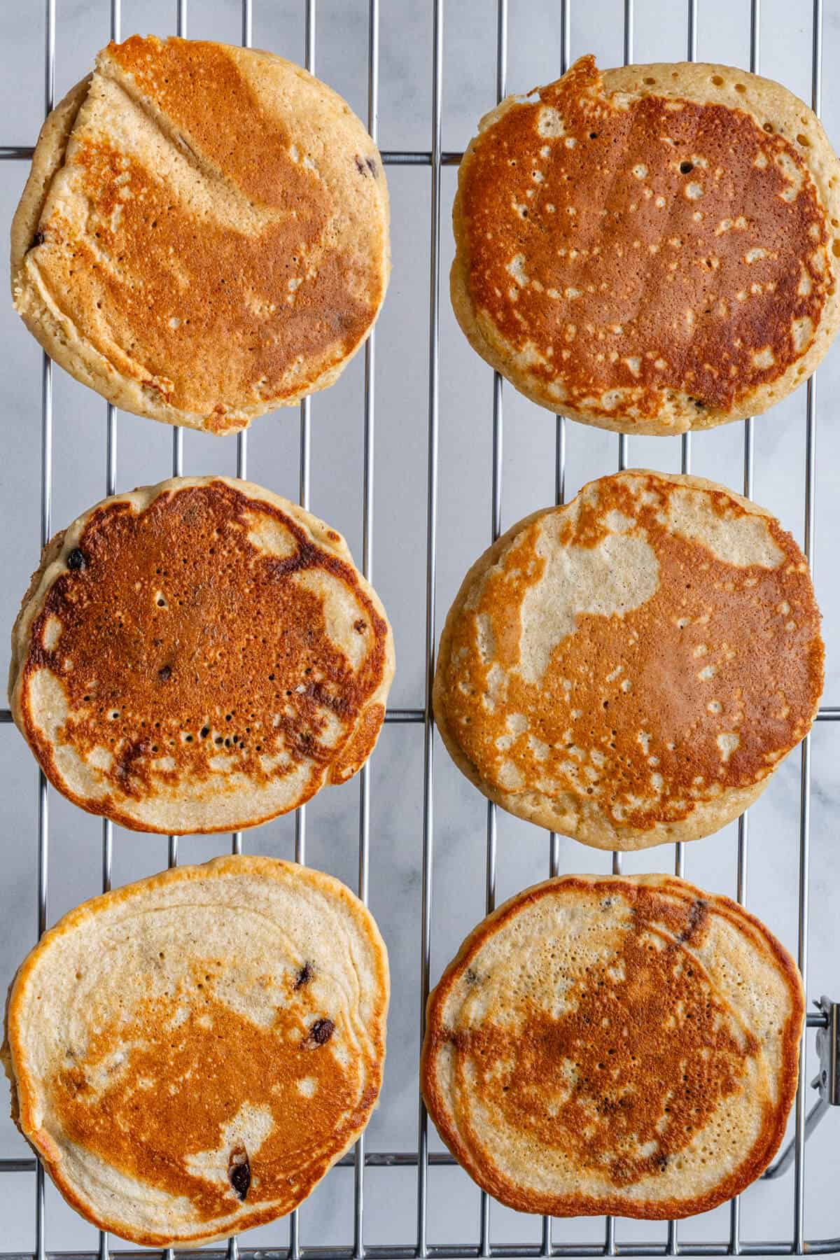 Cooked pancakes placed on a cooling rack