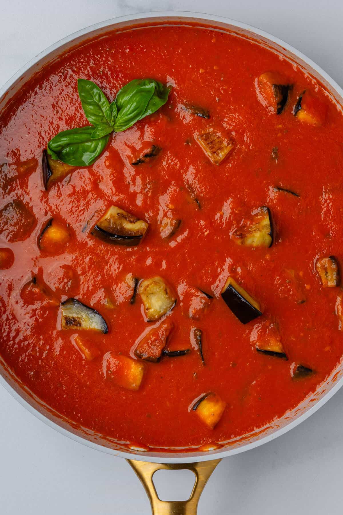 Pan of rich tomato sauce with eggplants