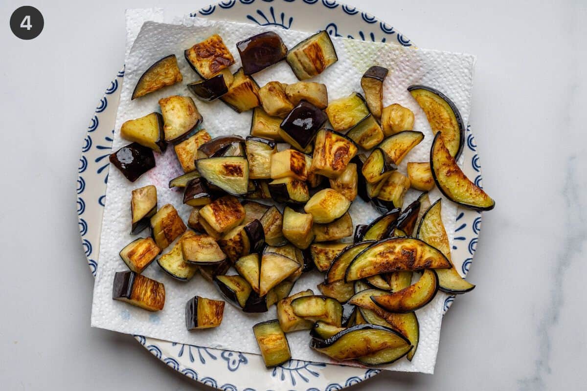 Fried eggplants on a paper towl on plate