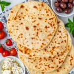 Yogurt flatbread served with olives, tomatoes and feta cheese