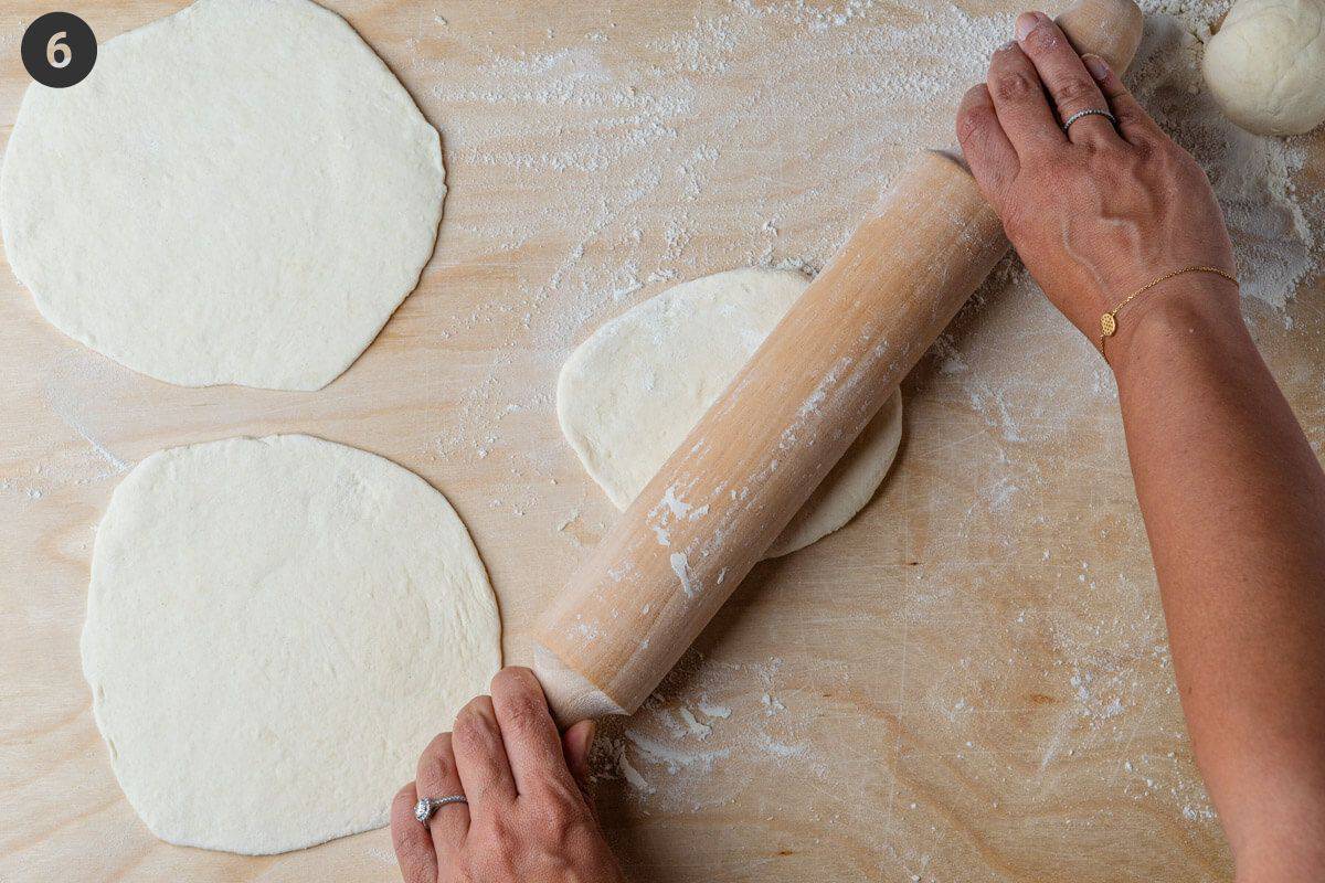 Dough being rolled with rolling pin