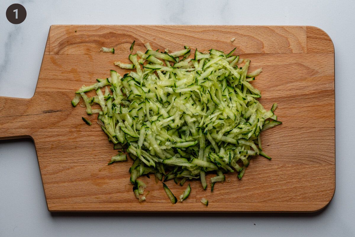 Grated cucumber on a cutting board