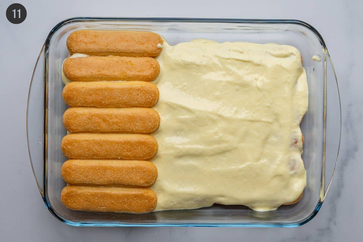 Second layer of soaked biscuits placed on top of cream