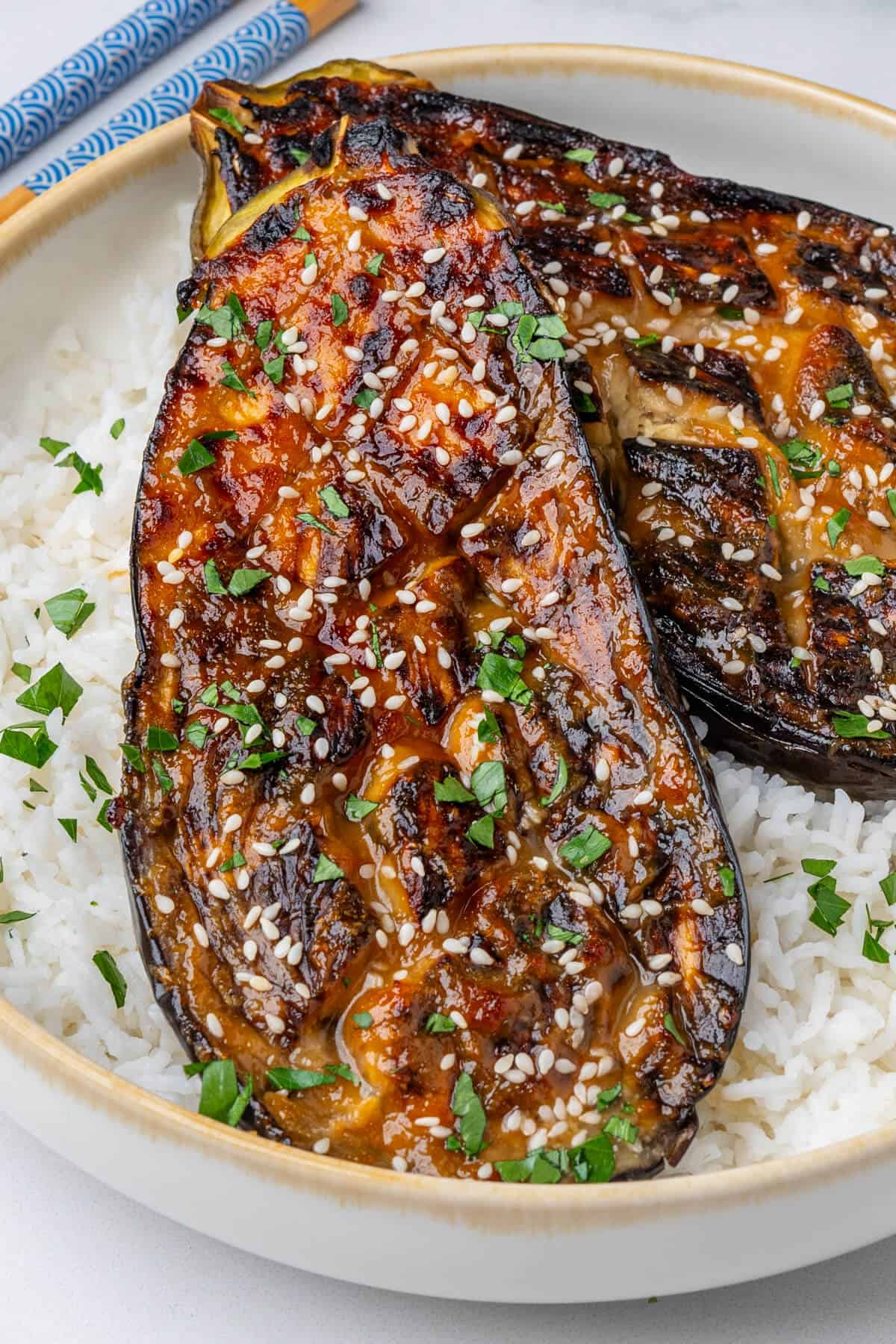 Miso eggplants in a bowl of rice with sesame seeds