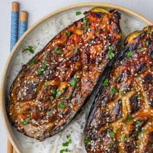 Miso eggplant topped with sesame seeds on a bowl of rice