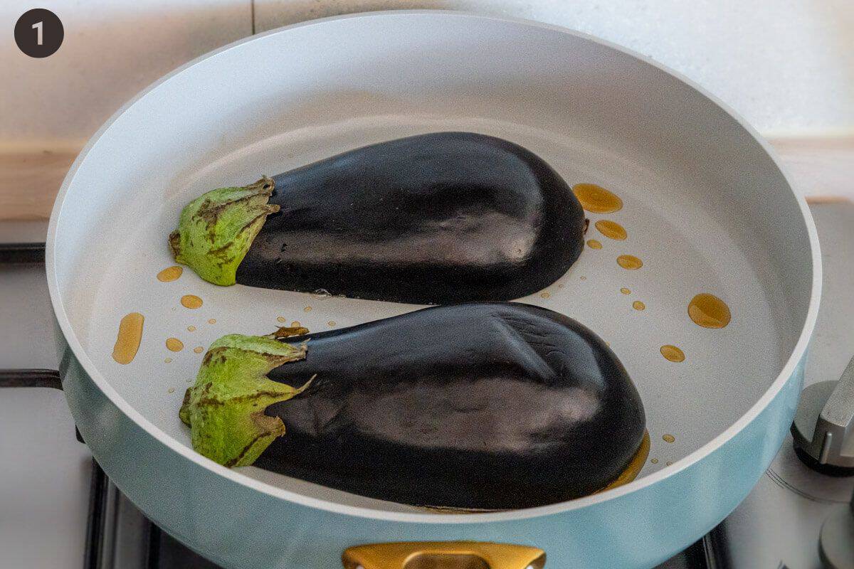 Eggplants flesh down on a fry pan
