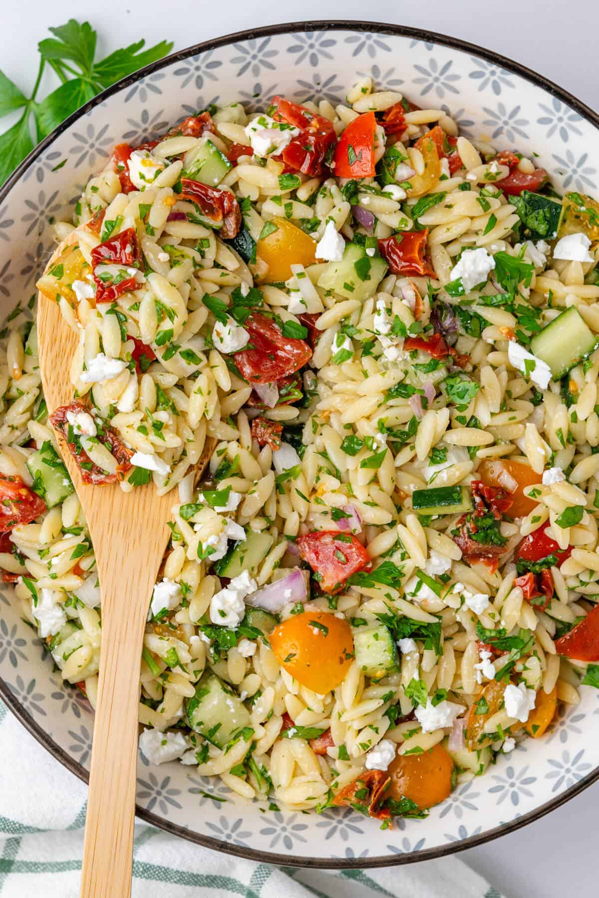 Spoon in a bowl of orzo risoni salad