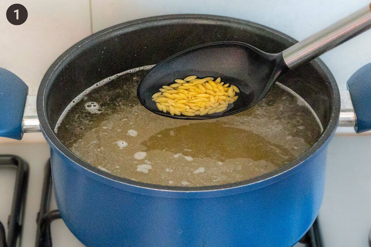 Orzo being boiled in a pot of boiling water