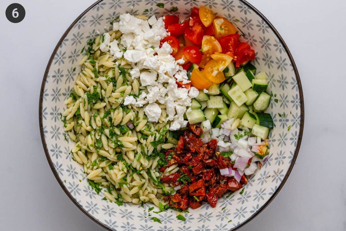 Salad ingredients in a large bowl before being mixed