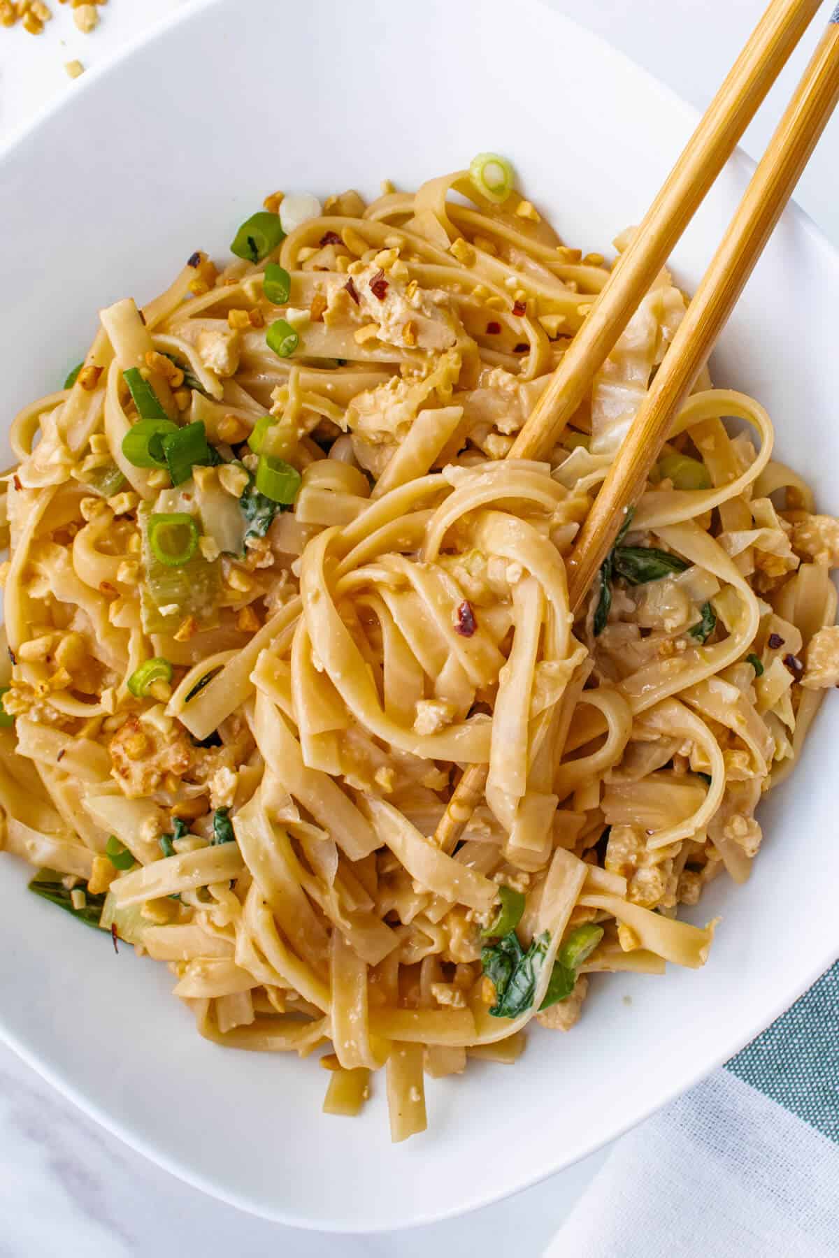 Chop sticks in a bowl of creamy noodles