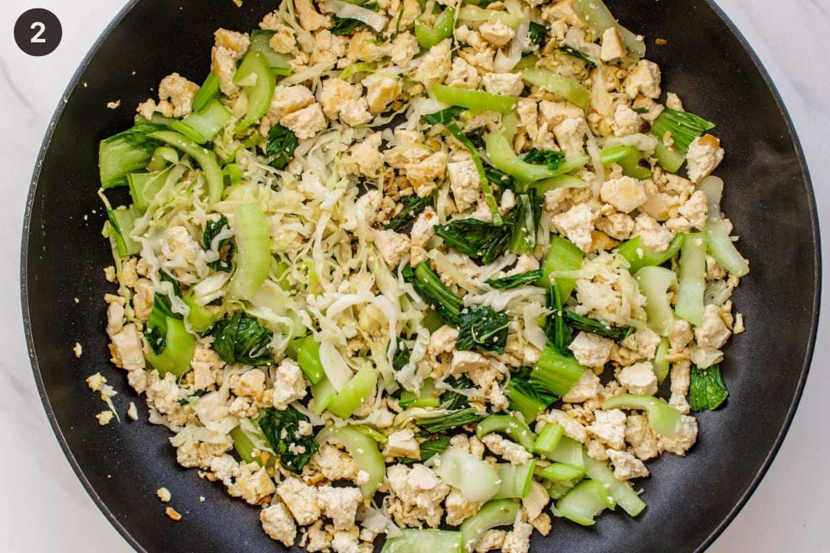 Tofu, bok choy and cabbage frying off on a pan
