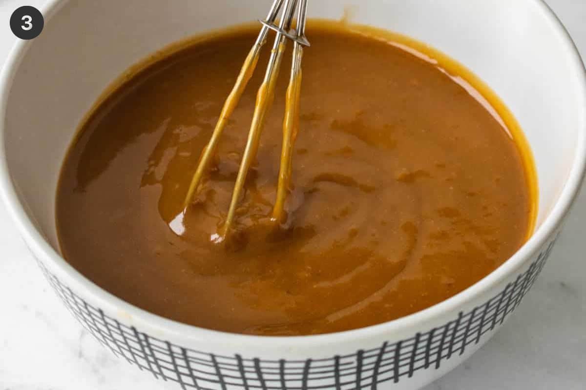 Peanut sauce in a bowl with a whisk