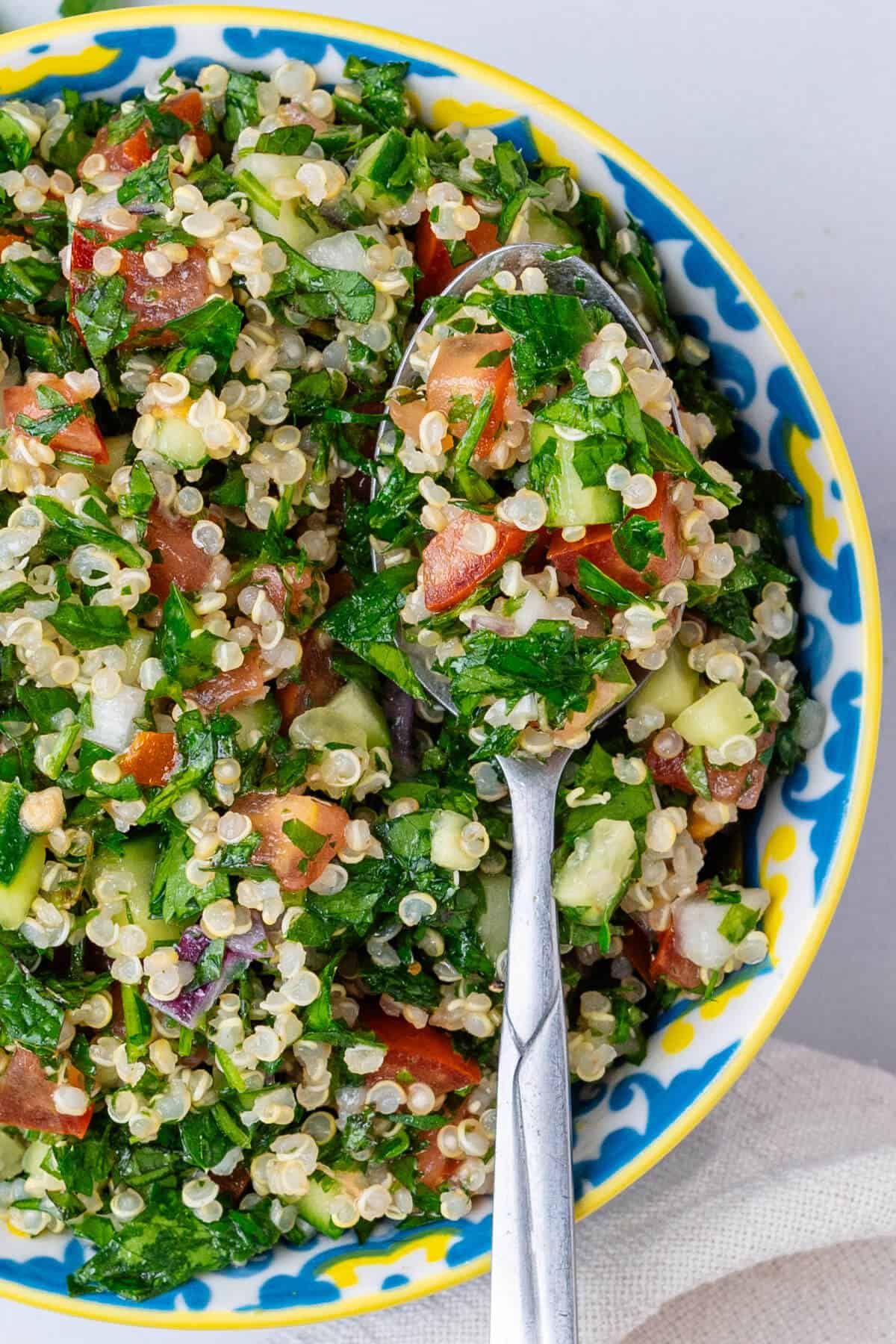 Spoon in a bowl of Quinoa Tabbouleh salad