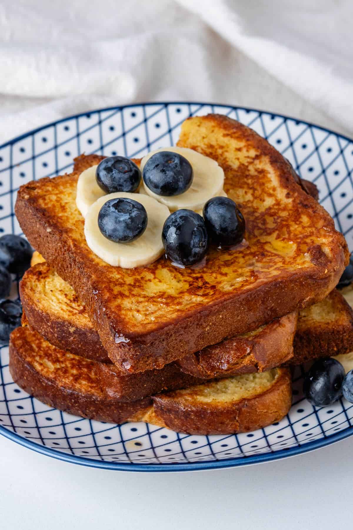 Brioche French Toast on plate with fresh berries and fruit