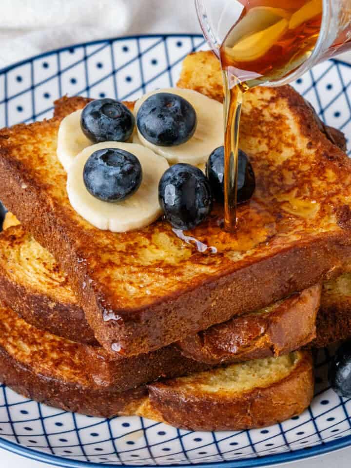 Maple syrup being poured on Brioche French Toast