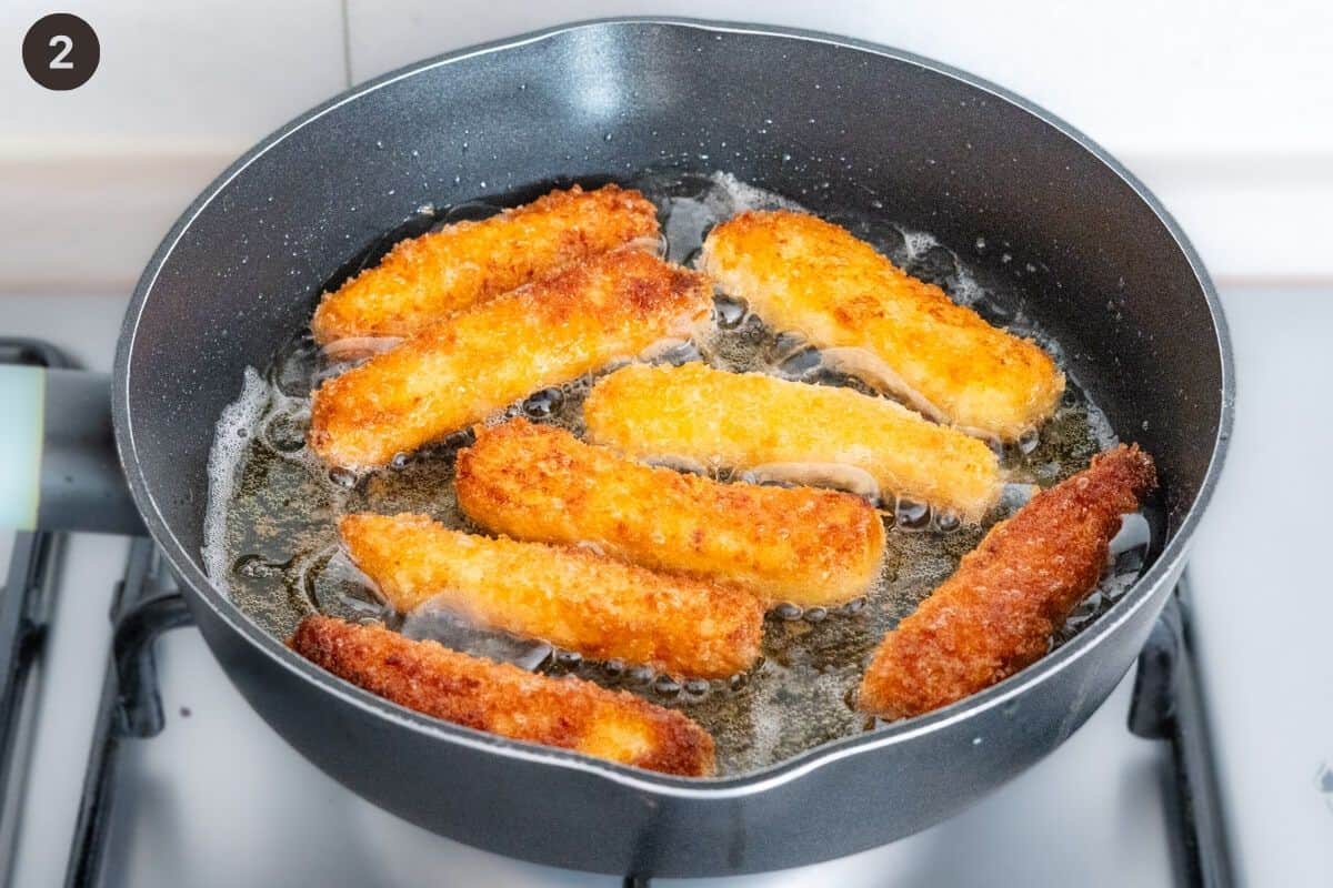 Fries flipped in a pan with oil