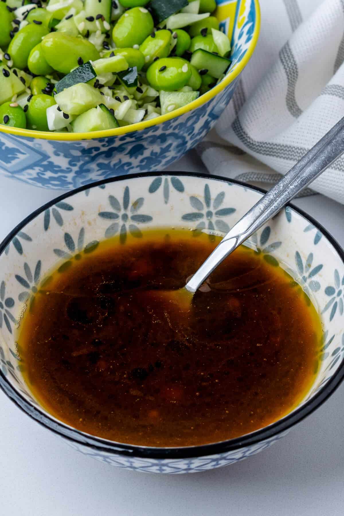 Sesame dressing in a bowl with a spoon